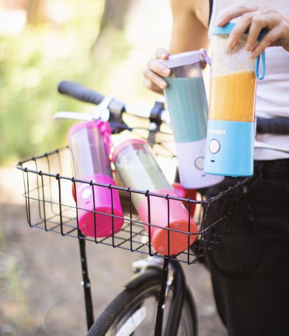 four colors of BlendJet2 portable blender in bicycle basket